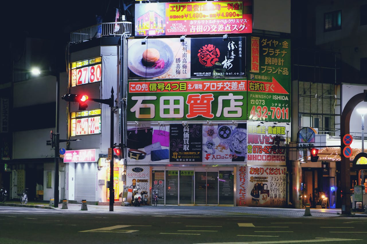 Colorful Japanese street with bright neon and billboard signs at night.